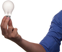Photo of a man holding a lightbulb, symbolizing innovation