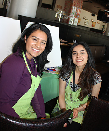 Summer students, Pareesa Bina and Yasna Sarwar at a CICS painting group activity